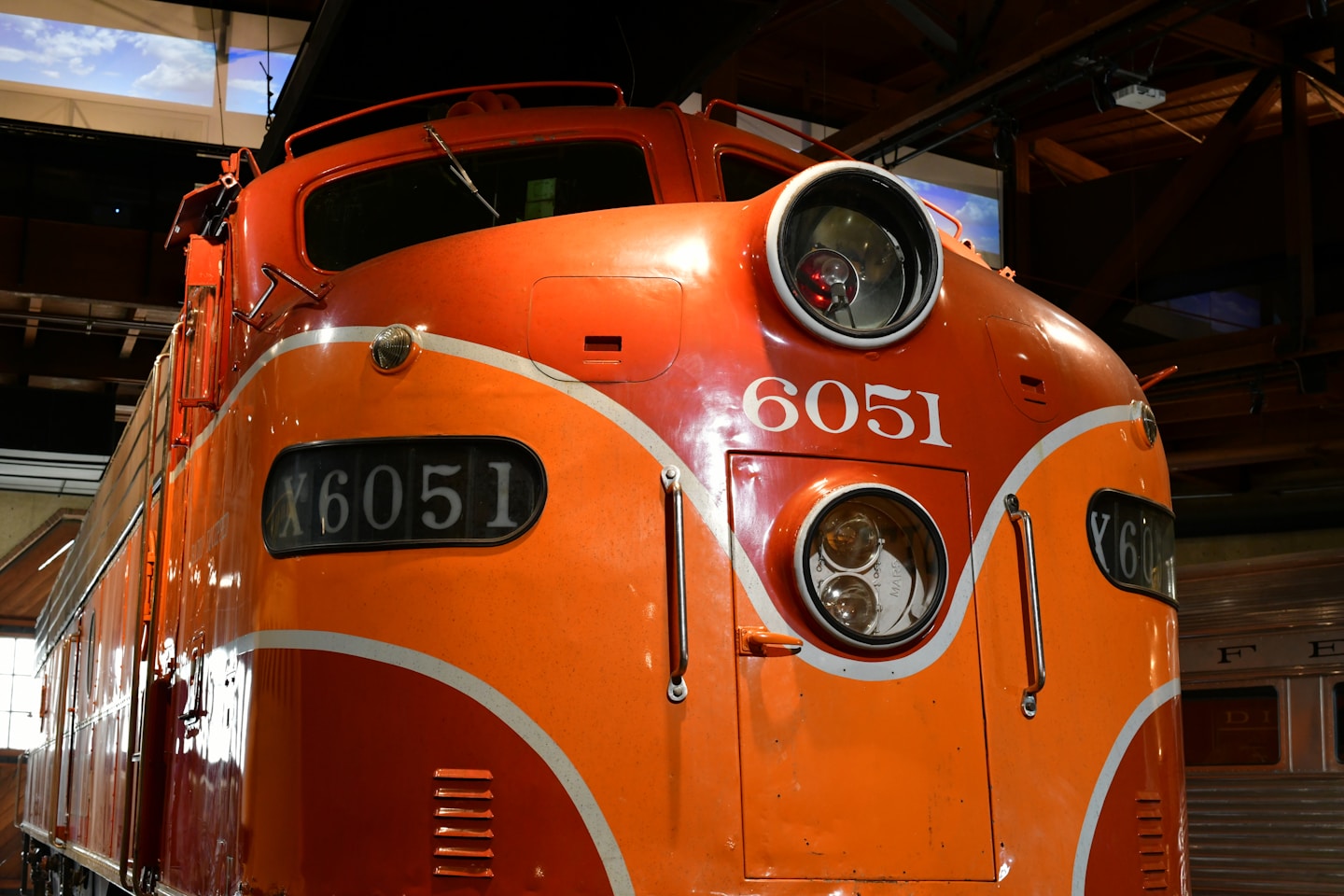 Orange and white train engine numbered 6051